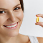 Vitamins. Healthy Eating. Happy  Girl With Omega-3 Fish Oil Caps