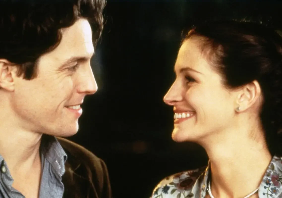 William et Anna souriant ensemble dans une scène réelle de Coup de foudre à Notting Hill