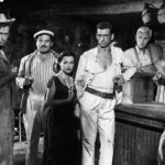Le Salaire de la peur (1953) : fin du film expliquée Les personnages du Salaire de la peur réunis au bar, dans le film de Clouzot de 1953